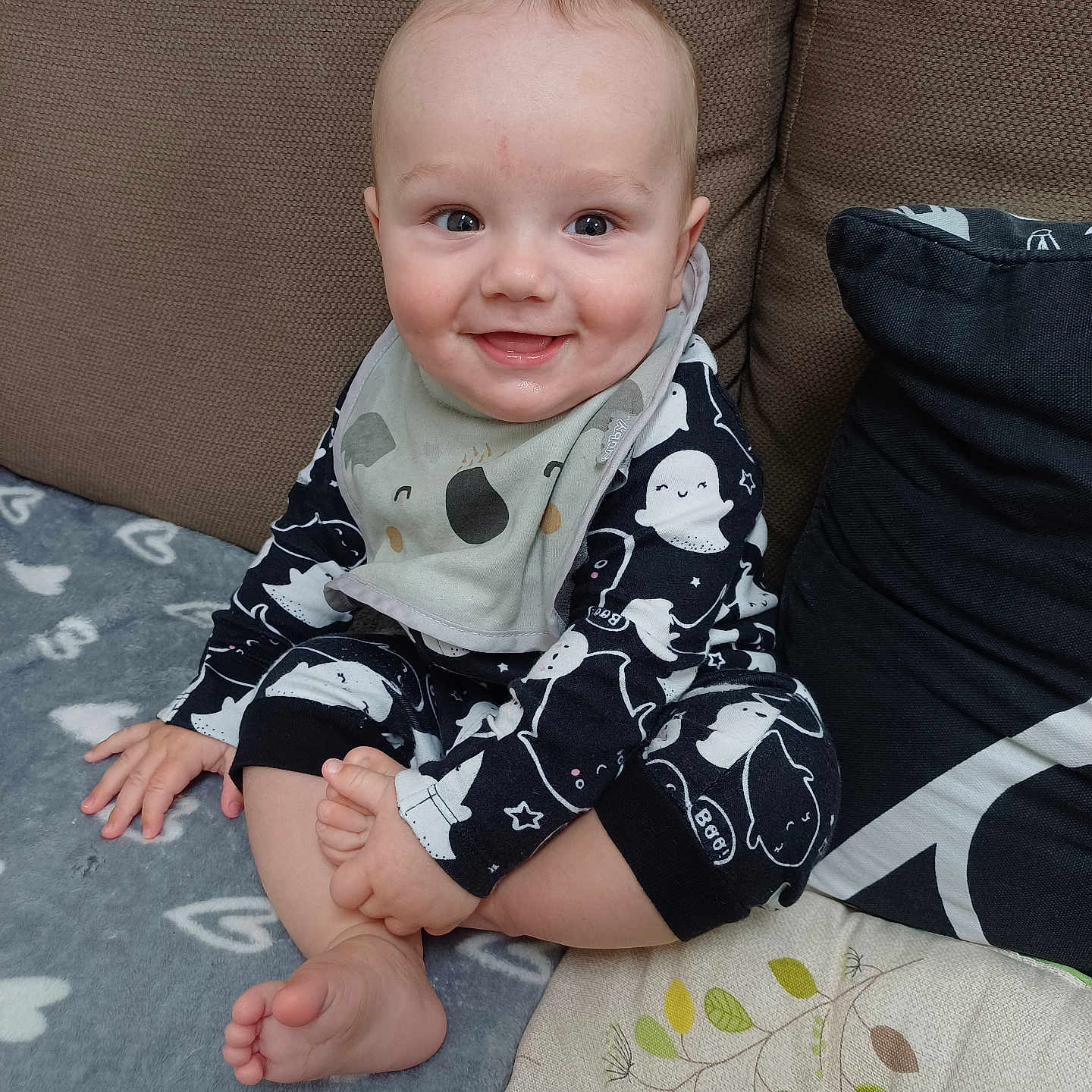 Rupert joined the competition — help win amazing prizes! baby, bib, blanket, child, clothing, couch, cozy, cushion, cute, face, foot, hand, happy, indoors, infant, pajamas, person, portrait, sitting, smiling