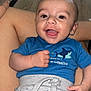Eden a rejoint le concours — aidez-le/la à gagner de superbes lots ! baby, child, smile, happy, face, blue_shirt, shorts, shark_pattern, person, human, clothing, indoor, legs, lap, hand, cute, infant, sitting, joy, portrait