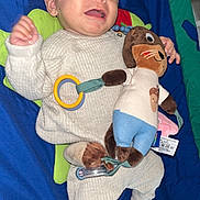 Eden participe au concours pour gagner de l'argent avec cette photo : baby, infant, knitwear, plush_toy, play_mat, smiling, happy, child, toy, colorful, floor, cute, person, lying_down, socks, indoors, soft_toy, fabric, cuddle, young