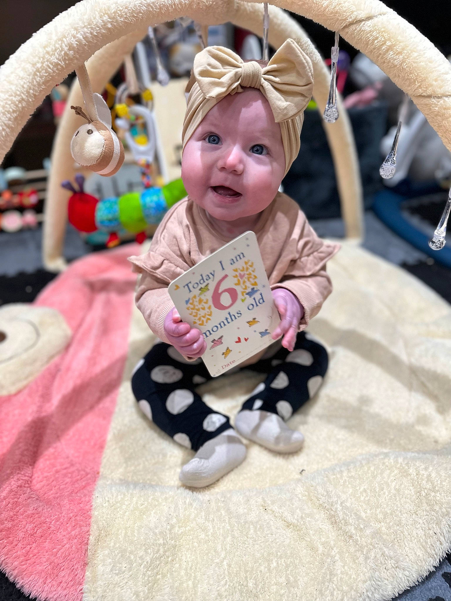 Astrid is registered to the contest to win money with this photo: baby, baby_carriage, baby_products, baby_toddler_clothing, child, event, fun, grass, happy, headwear, leisure, magenta, mammal, pattern, person, pink, product, sitting, sleeve, smile