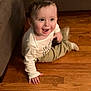 toddler, child, smiling, happy, floor, wooden_floor, couch, indoor, clothing, long_sleeve, pants, person, baby, face, expression, sitting, playful, home, young_child, casual