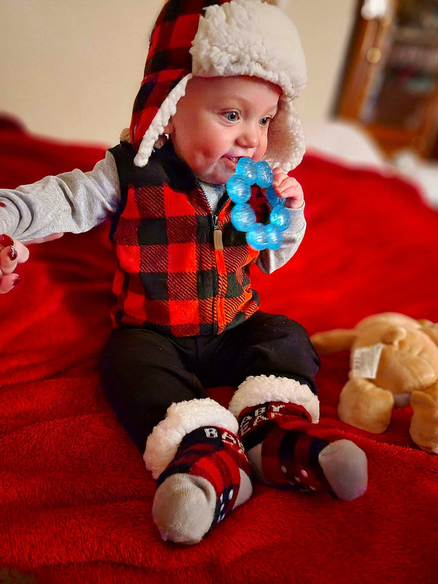 Travis is registered to the contest to win money with this photo: baby, baby_toddler_clothing, child, christmas, comfort, event, fur, headgear, headwear, holiday, knee, lap, pattern, person, plaid, sleeve, sock, tartan, textile, thigh