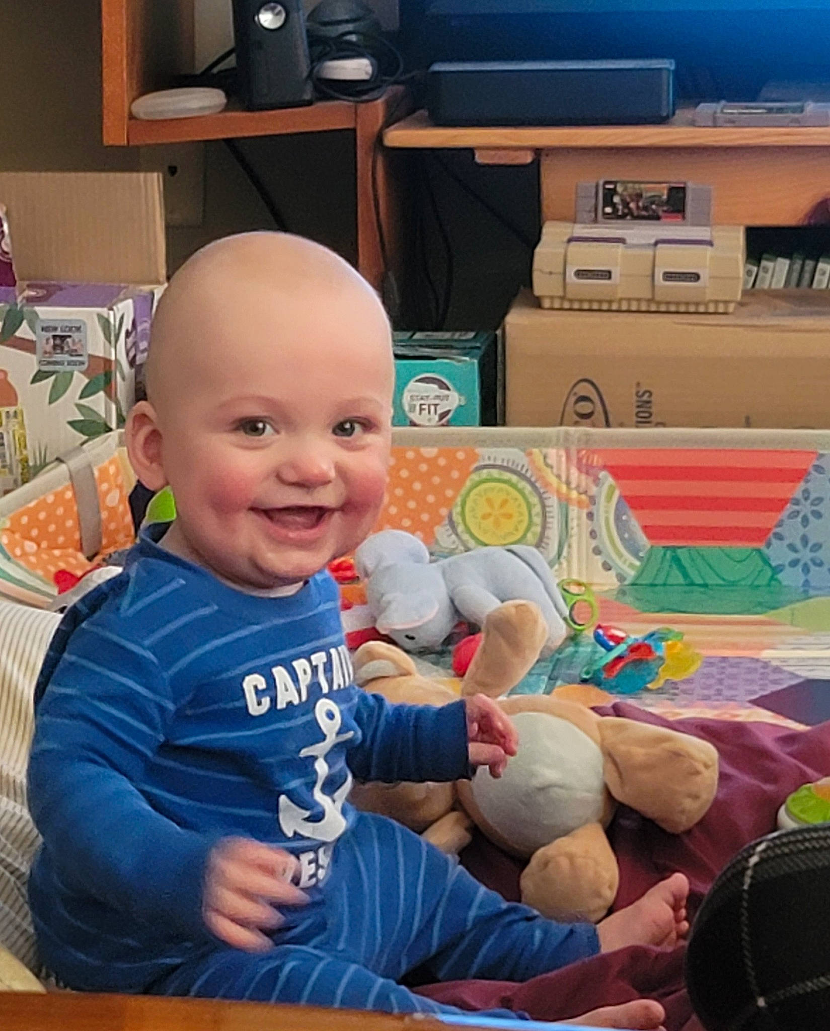 Travis joined the competition — help win amazing prizes! baby, baseball_cap, cabinetry, child, computer_keyboard, drawer, flooring, fun, happy, hat, home_appliance, joy, peripheral, person, room, shirt, sitting, skin, smile, t_shirt