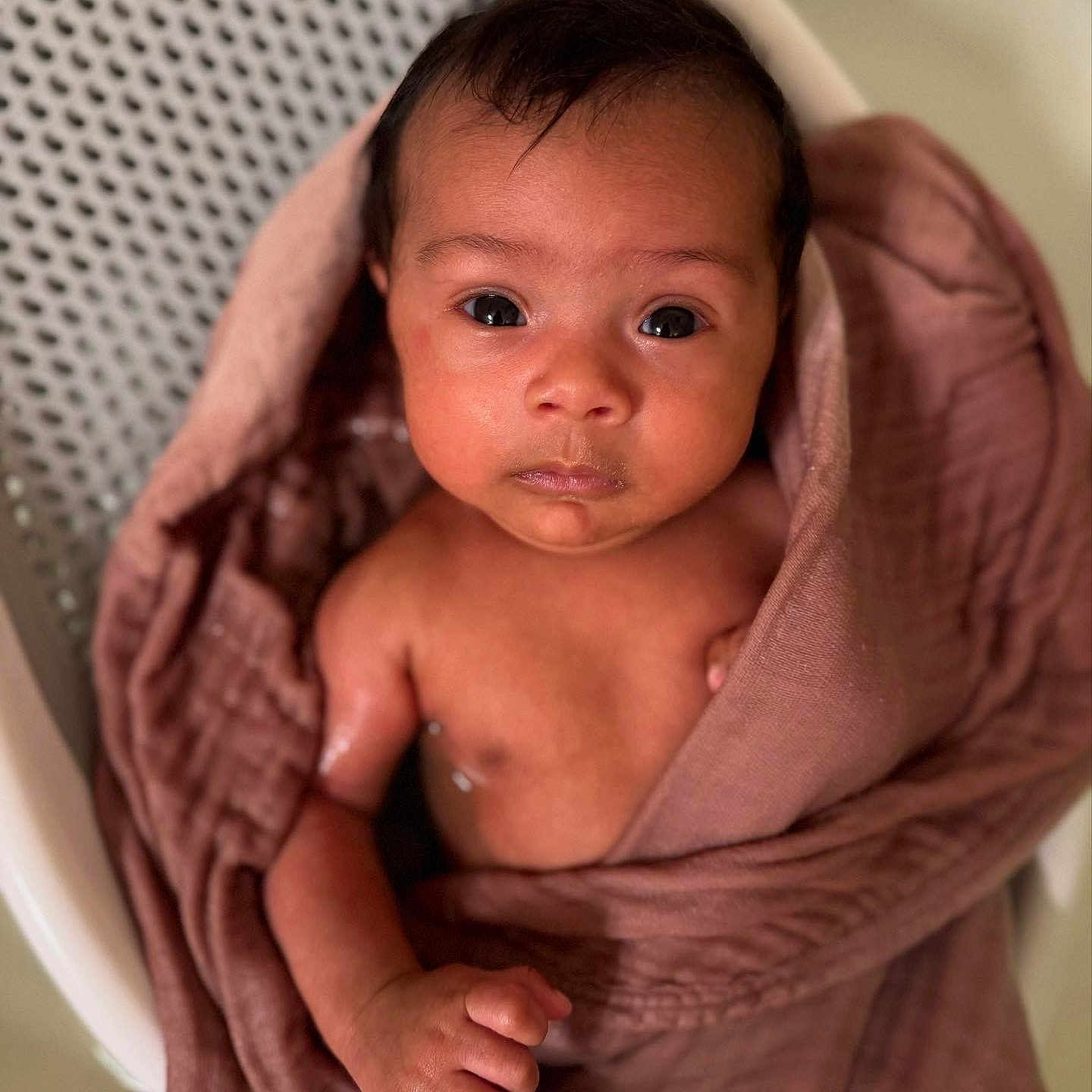 Christian is registered to the contest to win money with this photo: baby, bathing, blanket, clothing, face, happy, head, person, photography, portrait, sleeve, smile