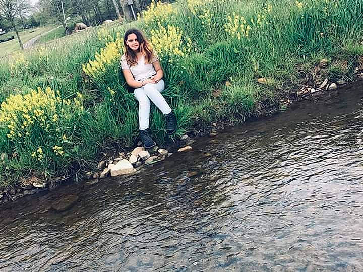 Kensey is registered to the contest to win money with this photo: bank, beauty, dress, footwear, grass, happy, joy, natural_environment, nature, people_in_nature, person, photography, plant, river, smile, spring, summer, tree, water, water_resources