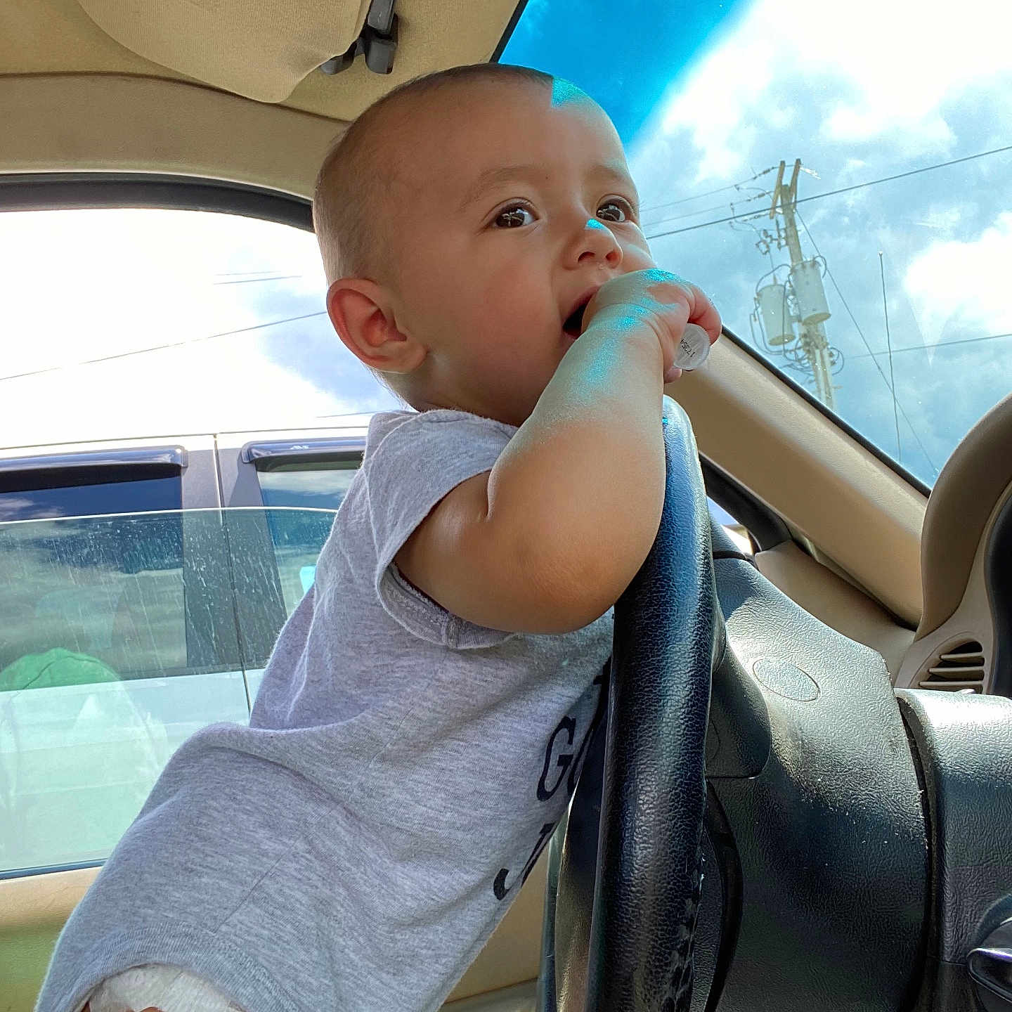Emerald is registered to the contest to win money with this photo: baby, bodypart, car, city, clothing, cream, dessert, face, finger, food, head, icecream, person, photography, portrait, shorts, sitting, t_shirt, transportation, vehicle