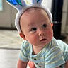 baby, child, bunny_ears, crawling, infant, portrait, indoors, striped_outfit, blue, headband, cute, curious, face, eyes, hands, floor, home, lock_screen, smartphone_screenshot, easter
