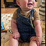 Elliott is registered to the contest to win money with this photo: baby, child, infant, smiling, happy, portrait, sitting, overalls, denim, striped_shirt, clothing, barefoot, indoors, bedroom, furniture, cushion, pillow, home, photograph, editing_screen