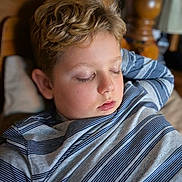 Nicholas joined the competition — help win amazing prizes! bed, blonde_hair, calm, casual_clothing, child, closeup, cozy, face, home, indoors, peaceful, person, pillow, portrait, relaxation, resting, sleeping, striped_shirt, wooden_headboard, young