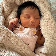 Raelynn joined the competition — help win amazing prizes! newborn, baby, sleeping, blanket, pink_clothing, soft_texture, infant, cozy, cute, peaceful, wrapped, knitted, wooden_buttons, skin, small_hands, indoors, closeup, resting, toddler, portrait
