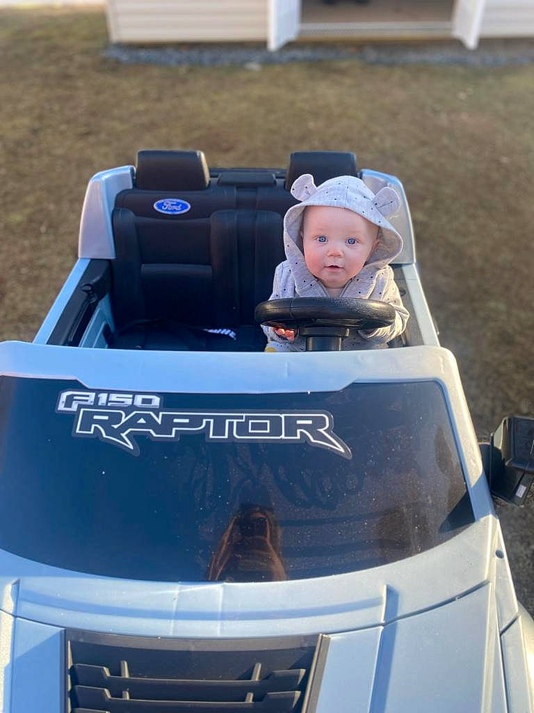 Elise is registered to the contest to win money with this photo: auto_part, automotive_design, automotive_exterior, automotive_lighting, automotive_tire, automotive_wheel_system, bumper, car, grille, headwear, helmet, hood, motor_vehicle, person, personal_luxury_car, personal_protective_equipment, product, tire, toddler, toy