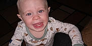 Remington is registered to the contest to win money with this photo: child, toddler, smiling, pajamas, indoor, person, face, hand, carpet, furniture, lap, home, cozy, flash, expression, cute, happy, clothing, legs, room