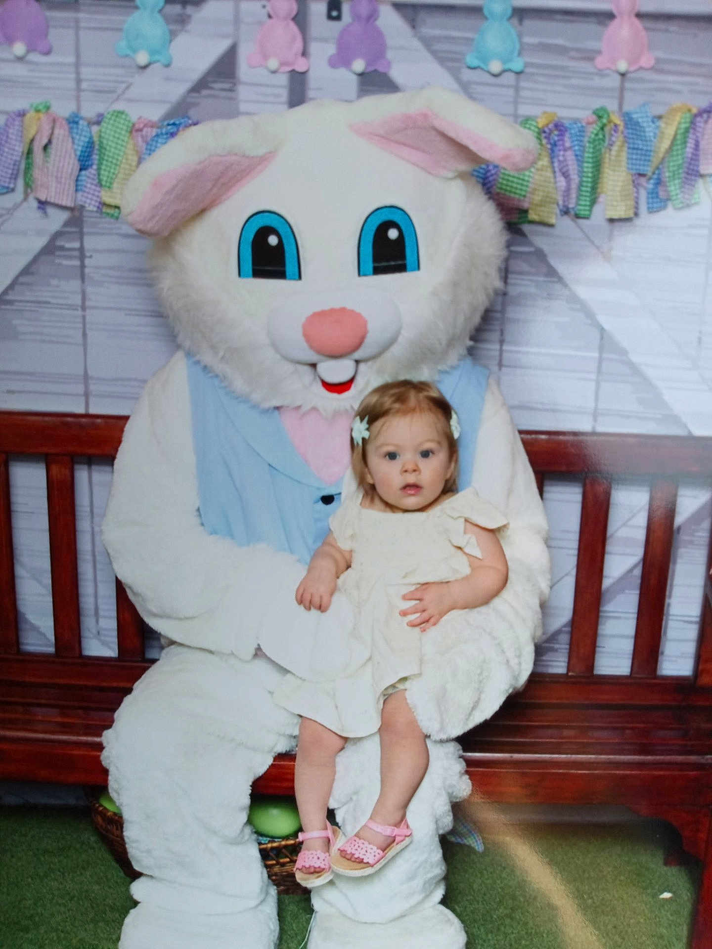 Clara joined the competition — help win amazing prizes! toddler, child, easter_bunny, mascot, costume, bench, dress, pink_sandals, hair_clips, indoor, decoration, pastel_colors, festive, celebration, cute, smiling, holiday, spring, plush, person