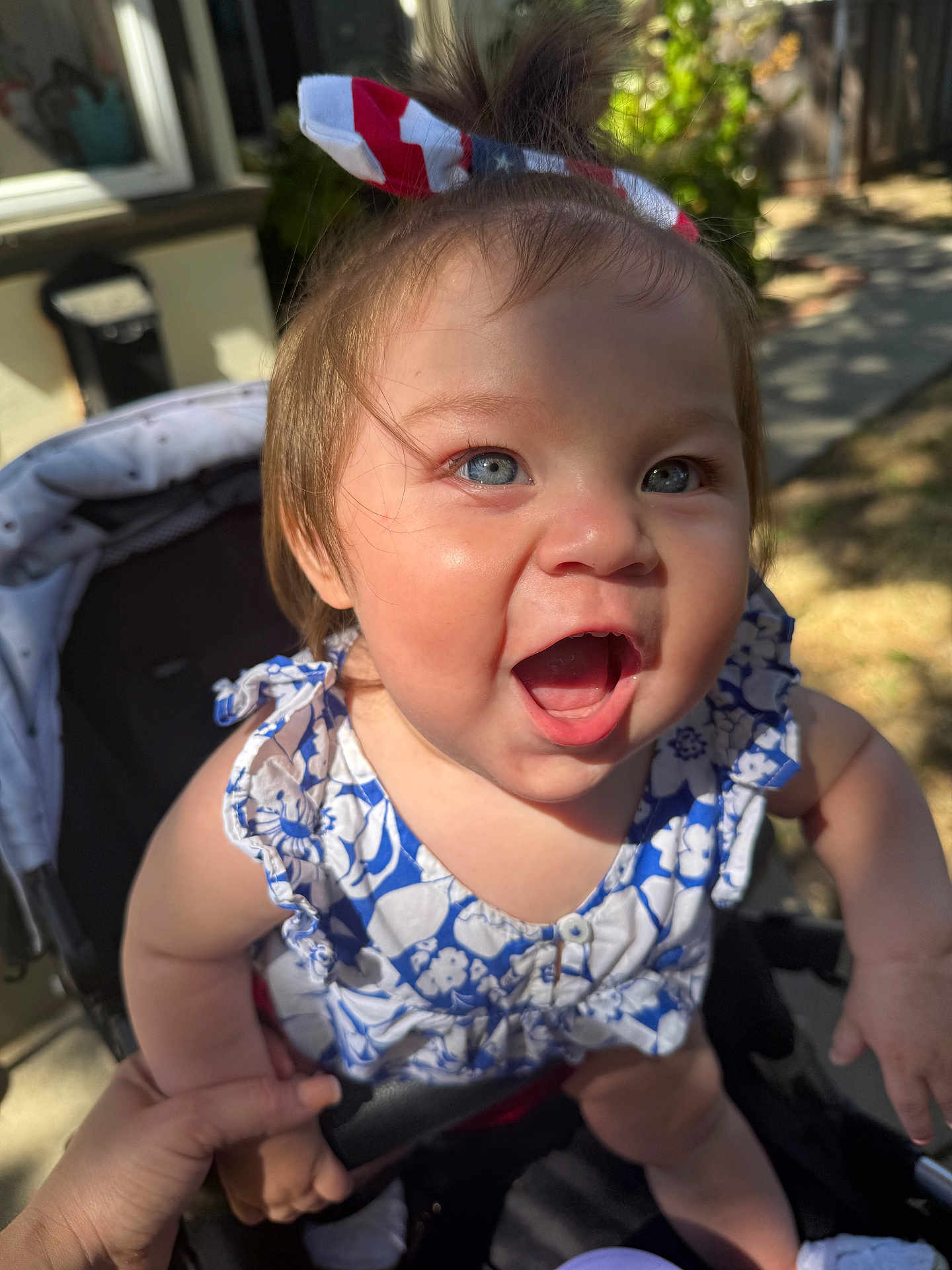 Daisylou joined the competition — help win amazing prizes! baby, child, smiling, blue_eyes, headband, american_flag, stroller, hand_holding, outdoor, sunlight, happy, cute, infant, person, summer, dress, playful, young, expression, skin