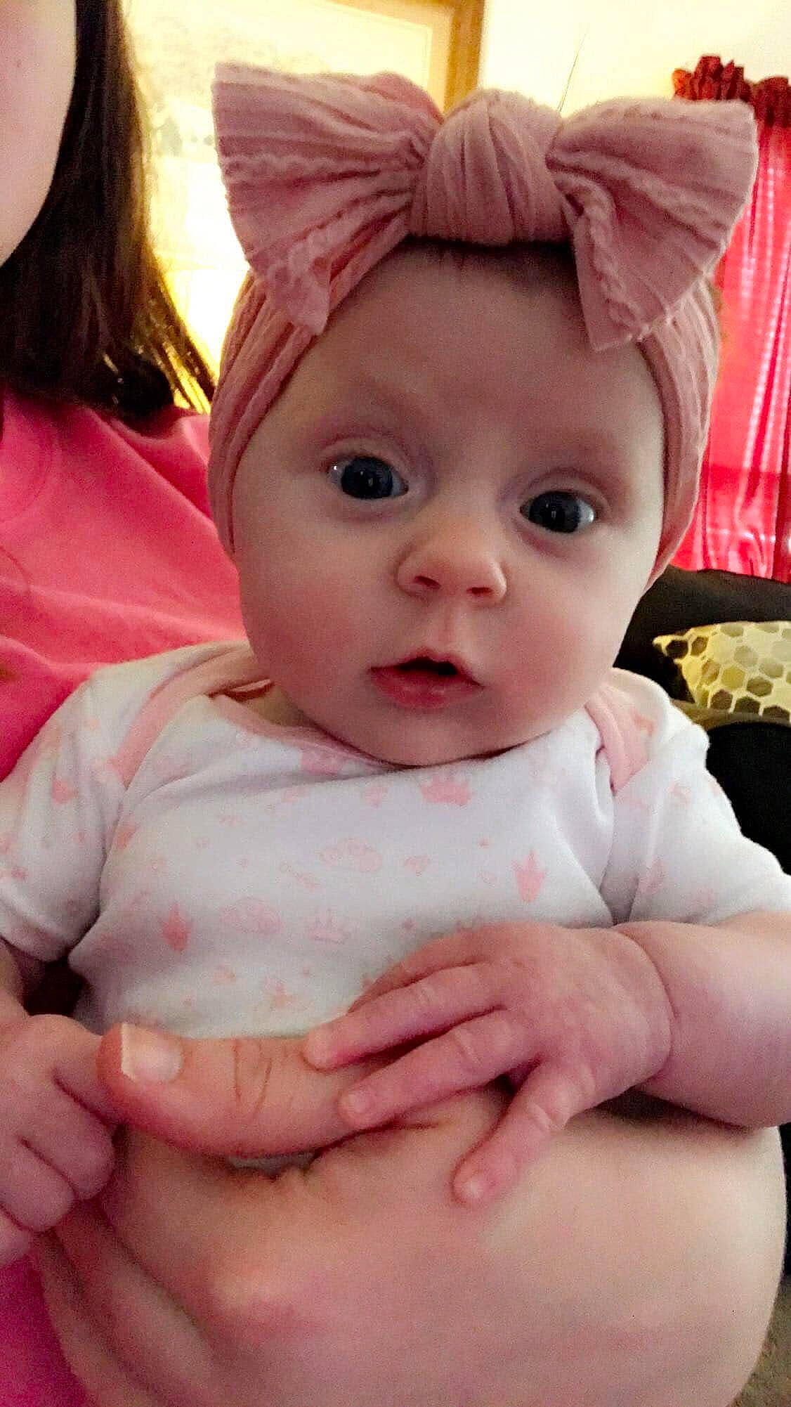 Lila joined the competition — help win amazing prizes! baby, baby_making_funny_faces, cheek, child, ear, eye, face, hand, head, headgear, lip, mouth, nose, person, pink, skin, surprise, thumb, toddler