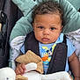 baby, blanket, blue_shirt, car_seat, child, clothing, comfort, curly_hair, cushion, cute, indoors, infant, mickey_mouse, person, portrait, seatbelt, serious_expression, soft_toy, stuffed_animal, toy