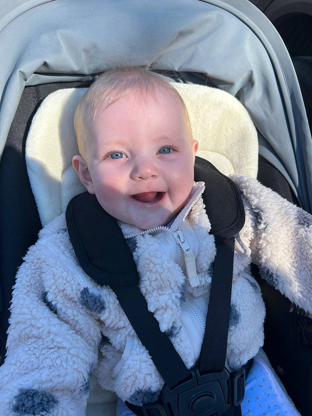 Olive joined the competition — help win amazing prizes! accessories, baby, bodypart, city, clothing, coat, face, happy, head, homedecor, jacket, mouth, person, photography, portrait, smile, stroller, teeth, transportation, vehicle