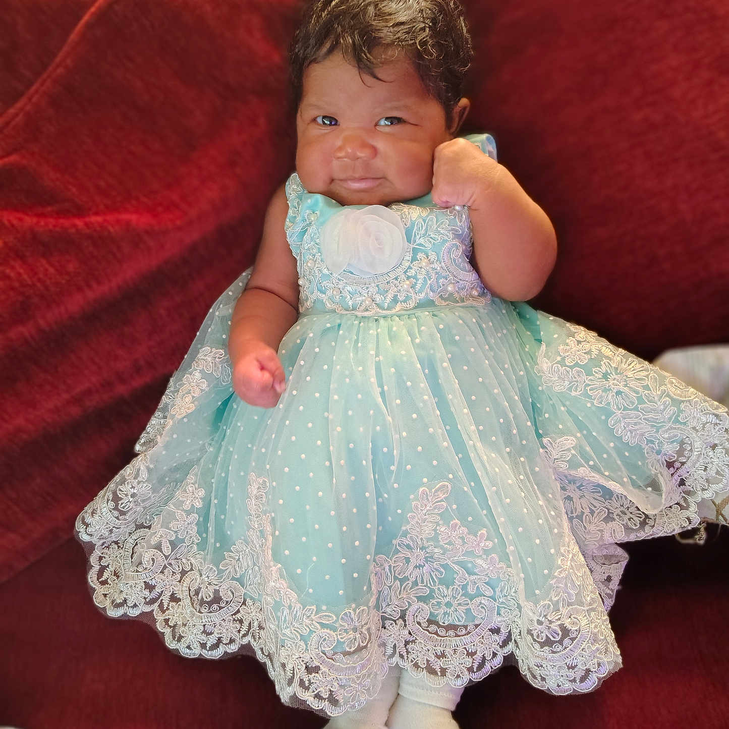 Malliah joined the competition — help win amazing prizes! baby, child, clothing, couch, cozy, cute, dress, fabric, fist, indoor, infant, lace, mint_green, person, portrait, red, sitting, smile, sock, young