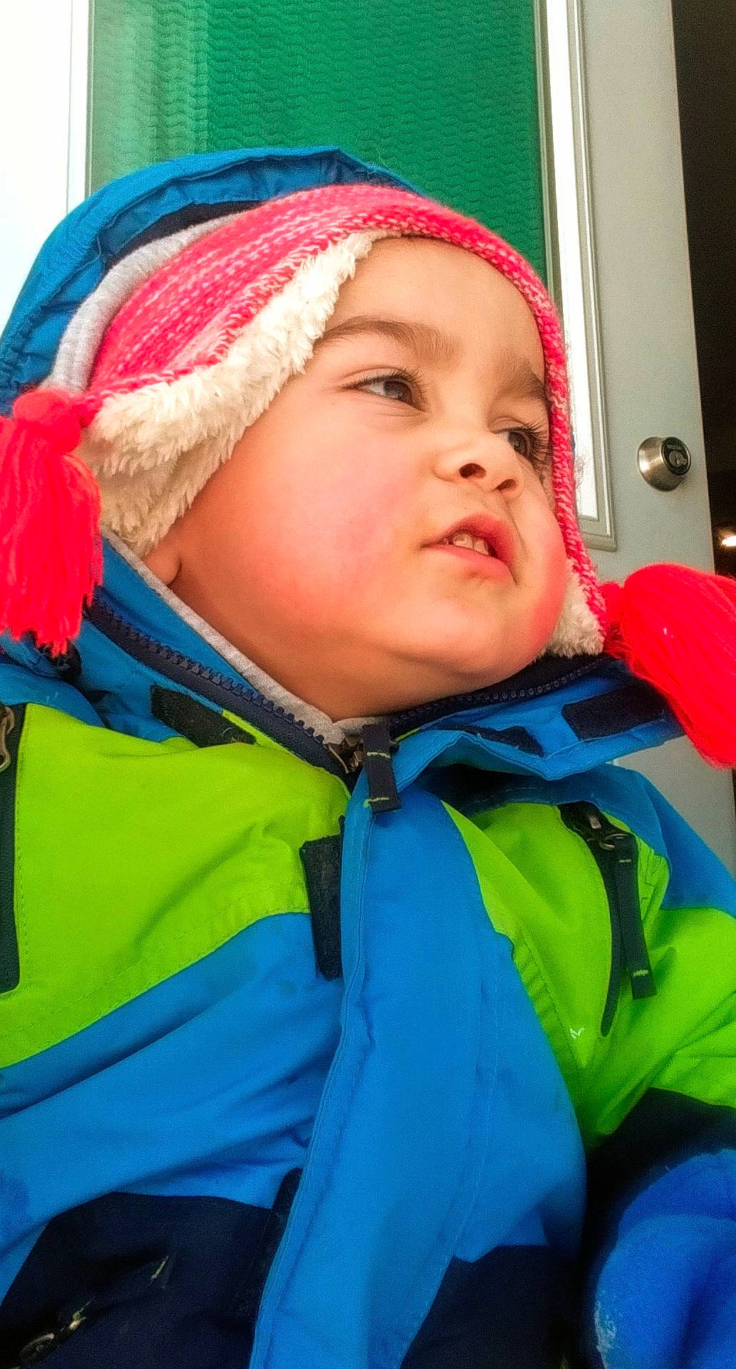 Harlem is registered to the contest to win money with this photo: blue, cap, cheek, child, electric_blue, fun, happy, headwear, hood, jacket, leisure, mouth, nose, outerwear, person, personal_protective_equipment, recreation, sleeve, toddler, tree