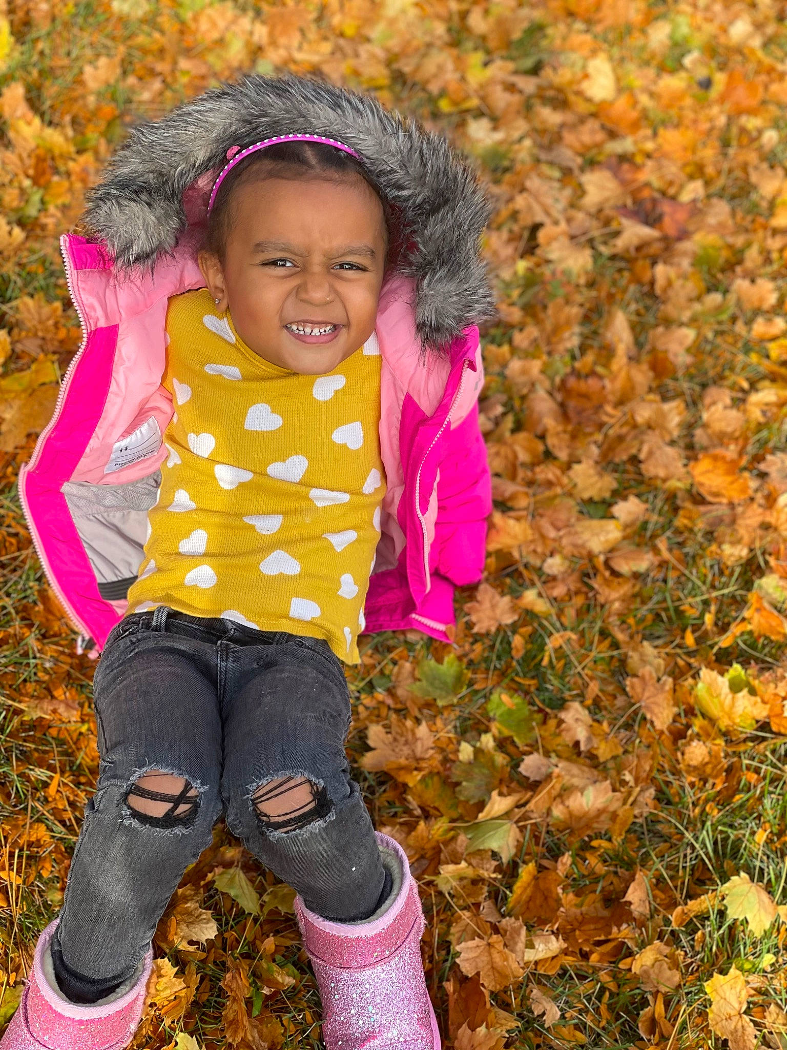 Azari is registered to the contest to win money with this photo: baby_toddler_clothing, child, fun, grass, happy, jacket, joy, leaf, leisure, magenta, nature, pattern, people_in_nature, person, pink, plant, sleeve, sock, soil, tints_and_shades