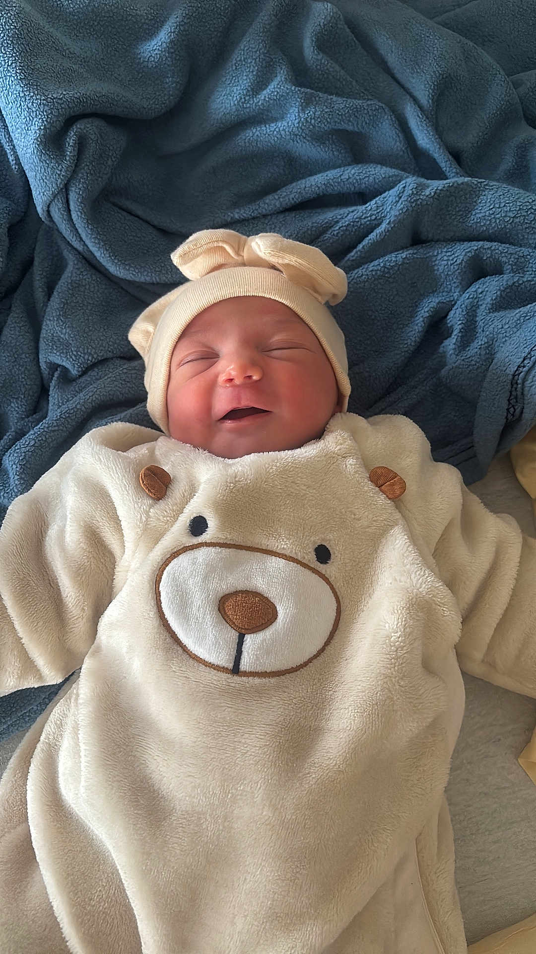 Ahezya participe au concours pour gagner de l'argent avec cette photo : baby, infant, sleeping, hat, bear_outfit, blanket, soft_texture, cute, cozy, child, clothing, headwear, smiling, face, portrait, newborn, warm, indoors, resting, adorable