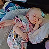 Haisley is registered to the contest to win money with this photo: baby, sleeping, infant, child, portrait, indoors, blanket, bed, floral_outfit, colorful_clothing, resting, peaceful, nap, closed_eyes, face, hand, cozy, home, candid, soft_lighting