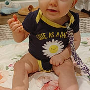 Haisley joined the competition — help win amazing prizes! baby, child, infant, smiling, portrait, sitting, bed, bedroom, floral, blanket, onesie, clothing, daisy, face, eyes, blonde_hair, indoor, happy, cute, photograph
