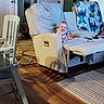 armchair, baby, blanket, blue_blanket, cartoon_character, child, cozy, face, furniture, high_chair, home, indoor, infant, living_room, portrait, recliner, rug, sitting, smiling, wood_floor