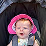 baby, child, blue_eyes, pink_hat, stroller, sunhat, outdoor, infant, cute, summer_clothes, safety_harness, curious_expression, light_skin, sunlight, portrait, closeup, seat, baby_girl, happy, daytime