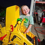 Marshall joined the competition — help win amazing prizes! child, toy, construction_vehicle, yellow, smiling, indoor, garage, workshop, clothing, person, small_vehicle, happy, boy, play, machine, floor, plastic, vehicle, toddler, casual