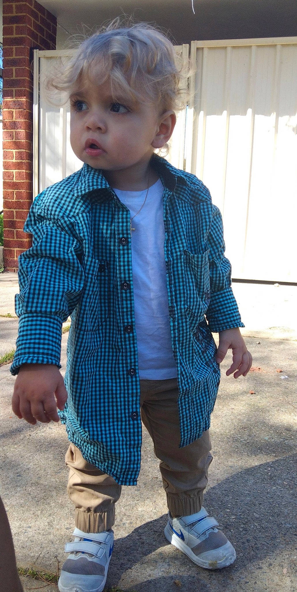 Cassius is registered to the contest to win money with this photo: blazer, blue, collar, denim, dress_shirt, face, hair, hairstyle, head, lip, neck, outerwear, people, person, plaid, sleeve, standing, tartan, tie, toddler