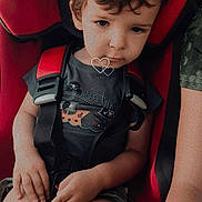 Logan a rejoint le concours — aidez-le/la à gagner de superbes lots ! black, car_seat, child, closeup, expression, face, hair, hands, heart_overlay, indoors, legs, pirate, portrait, red, safety, seat_belt, shirt, shorts, sitting, young