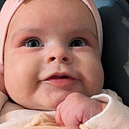 Seraphina joined the competition — help win amazing prizes! baby, blanket, bow, chubby_cheeks, close_up, clothing, cute, expression, face, hand, headband, indoors, infant, person, pink, portrait, skin, smile, soft_lighting, young_child