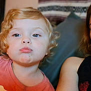 Kinleigh joined the competition — help win amazing prizes! child, toddler, adult, portrait, selfie, face, curly_hair, red_hair, blue_eyes, pout, serious_expression, pink_shirt, black_shirt, family, indoors, couch, close_up, photograph, headshot, home