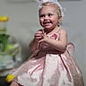 Kinleigh is registered to the contest to win money with this photo: toddler, child, baby, dress, pink, bunny_ears, smile, happy, indoors, person, cute, feet, hands, portrait, costume, headwear, fun, celebration, blurred_background, sitting