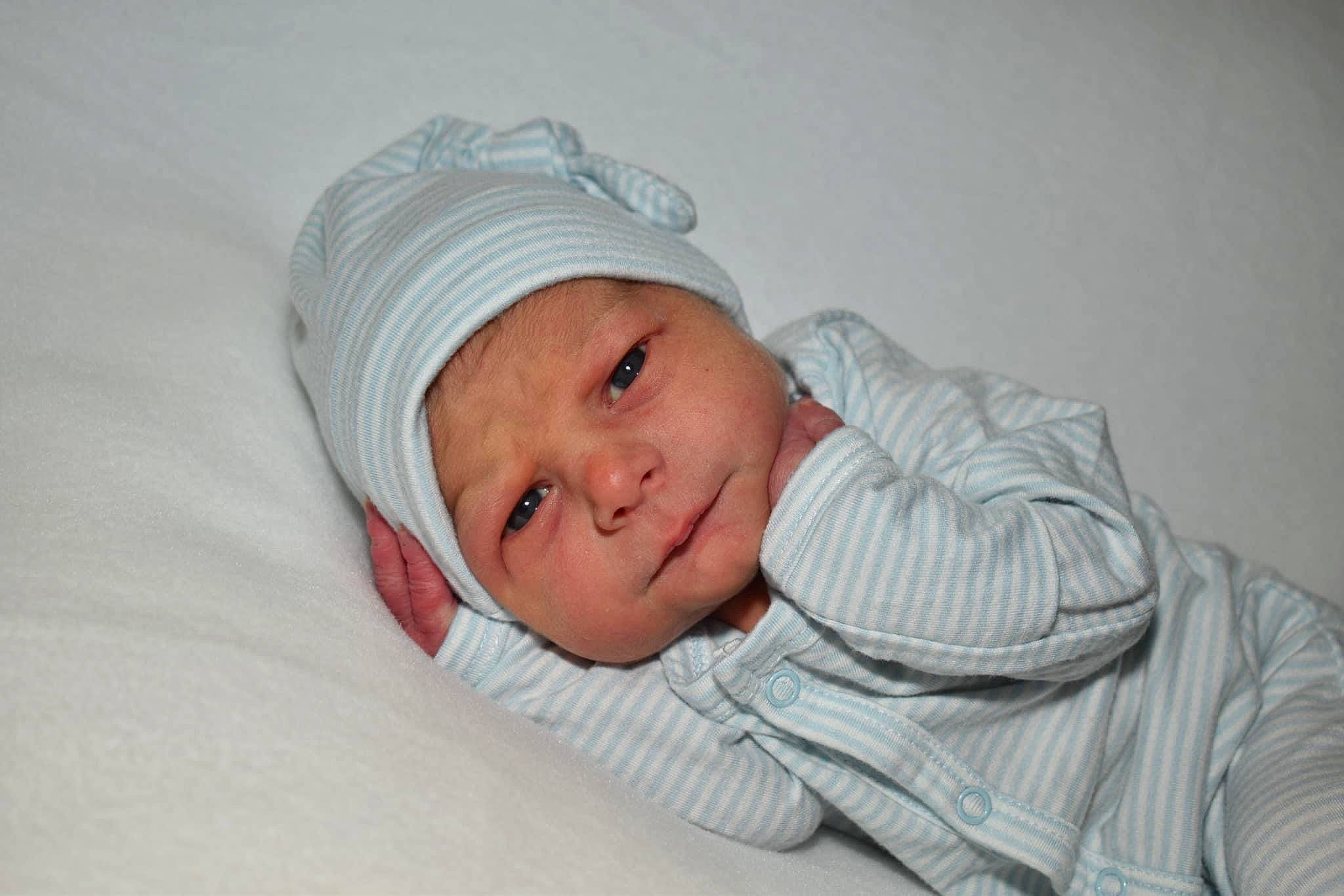 Michael is registered to the contest to win money with this photo: baby, baby_sleeping, baby_toddler_clothing, beanie, cap, child, comfort, headwear, linens, person, portrait_photography, sitting, sleep, sleeve, smile, toddler, wool