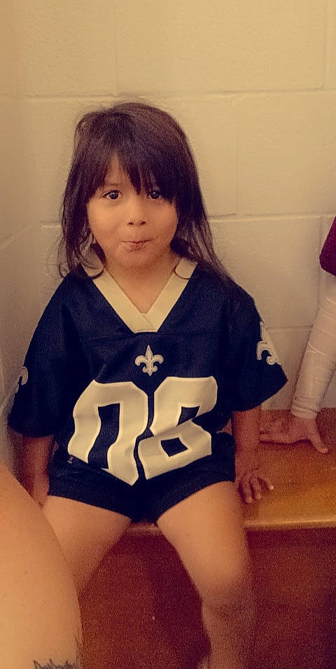 Rayna is registered to the contest to win money with this photo: abdomen, black_hair, chest, child, cool, eye, happy, human_body, human_leg, knee, leotard, long_hair, neck, person, skin, sleeve, sportswear, t_shirt, thigh, trunk