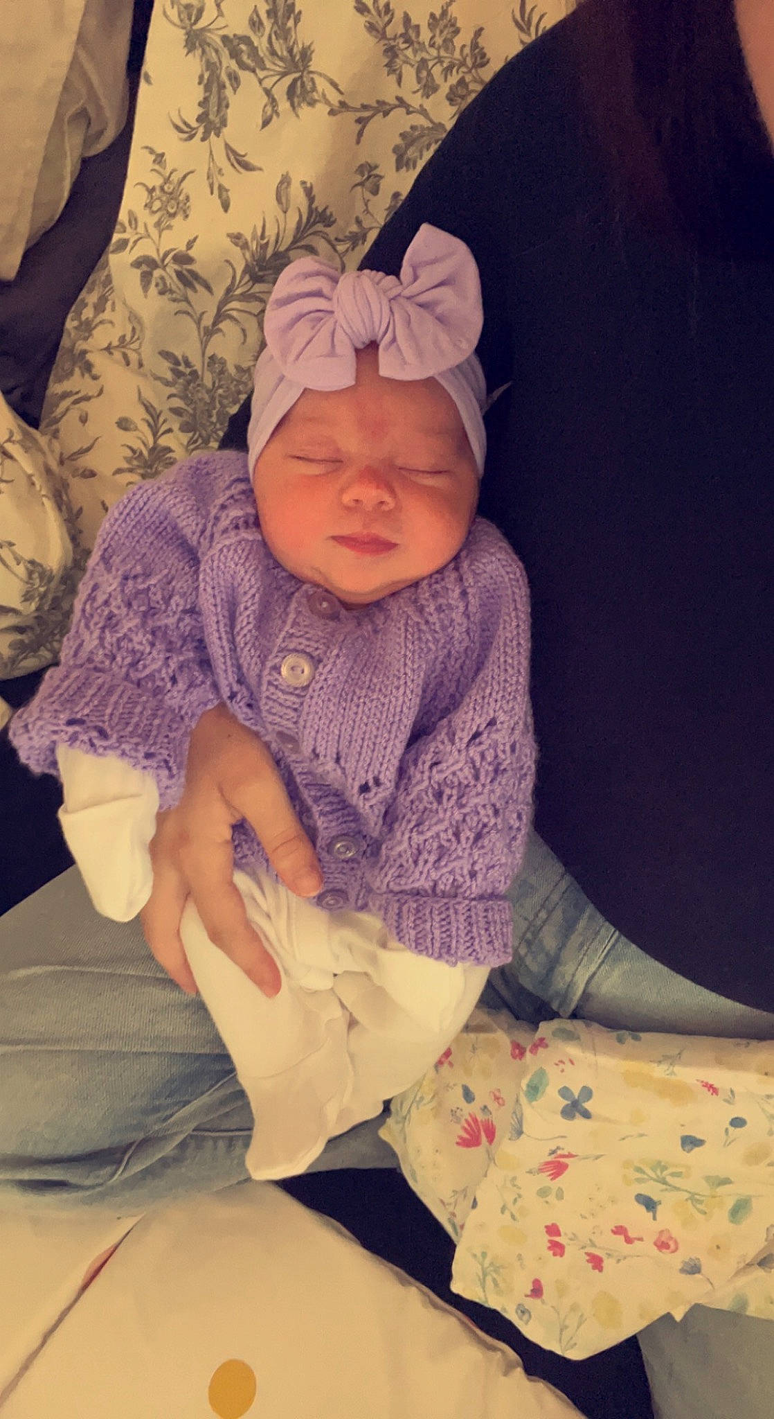 Isla-rose is registered to the contest to win money with this photo: baby, baby_products, baby_toddler_clothing, beanie, cap, cheek, comfort, fashion_accessory, hand, headwear, knit_cap, lap, outerwear, pattern, people, person, purple, sitting, skin, sleeve