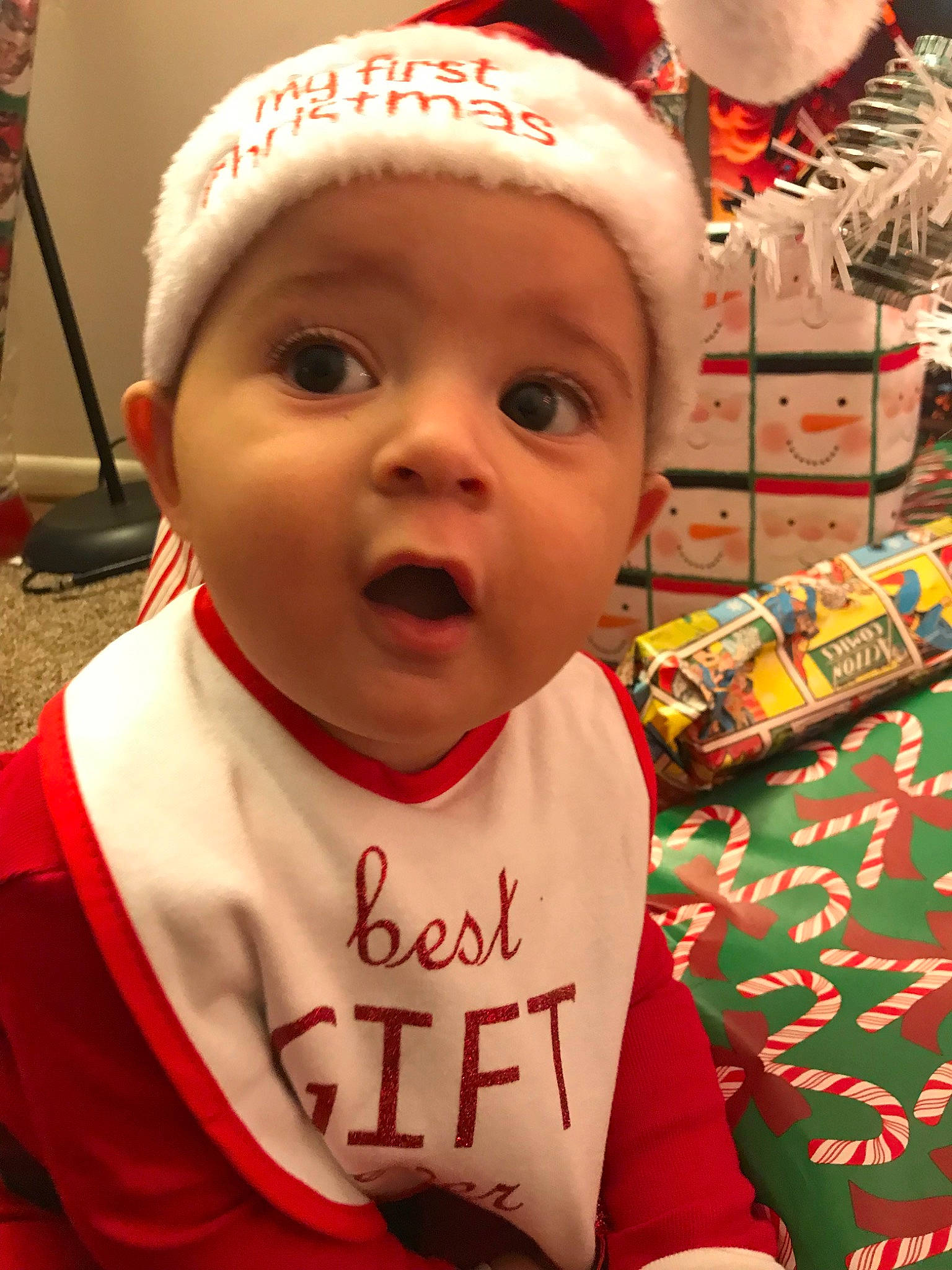 Cassius is registered to the contest to win money with this photo: baby, child, christmas, christmas_eve, fictional_character, holiday, person, surprise, toddler