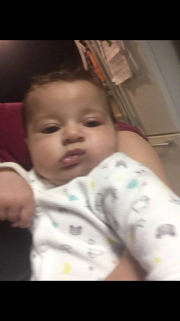 Cassius is registered to the contest to win money with this photo: baby, cheek, child, chin, ear, eye, eyebrow, face, facial_expression, forehead, head, iris, lip, mouth, nose, person, sitting, skin, smile, toddler