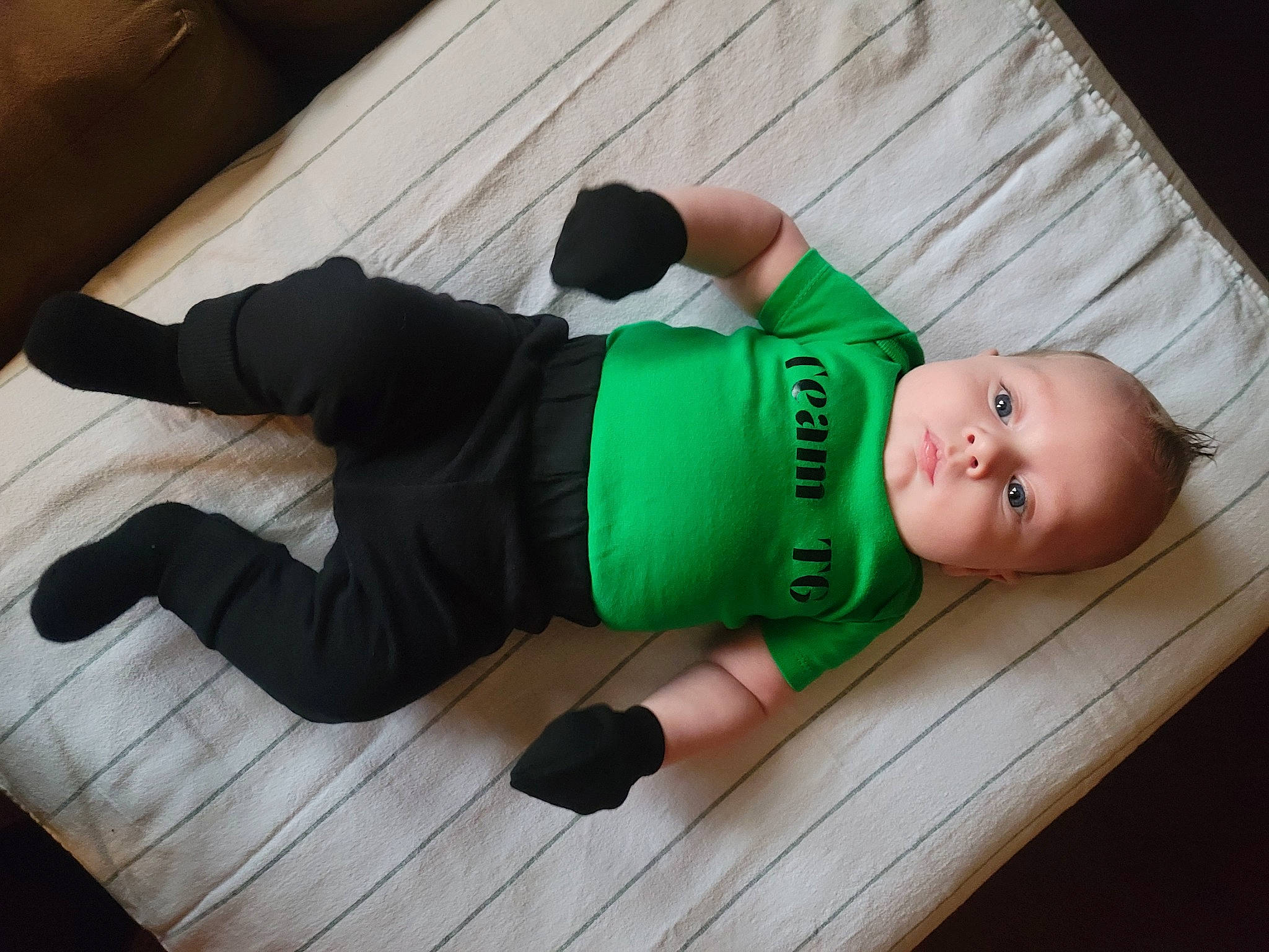 Pierson is registered to the contest to win money with this photo: baby, baby_toddler_clothing, child, comfort, elbow, floor, flooring, foot, hardwood, human_leg, joint, knee, leg, leisure, person, sitting, t_shirt, thigh, toddler, wood