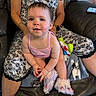 Aspen joined the competition — help win amazing prizes! baby, child, woman, person, sitting, couch, clothing, floral_pattern, pink_tank_top, slippers, toy, blanket, phone, leather, indoor, smiling, happy, hands, face, portrait
