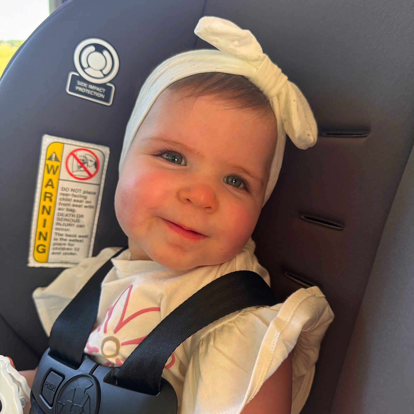 Aspen is registered to the contest to win money with this photo: baby, child, car_seat, headband, smile, seatbelt, infant, safety, cute, portrait, clothing, girl, indoors, closeup, person, seat, happy, face, young, child_seat
