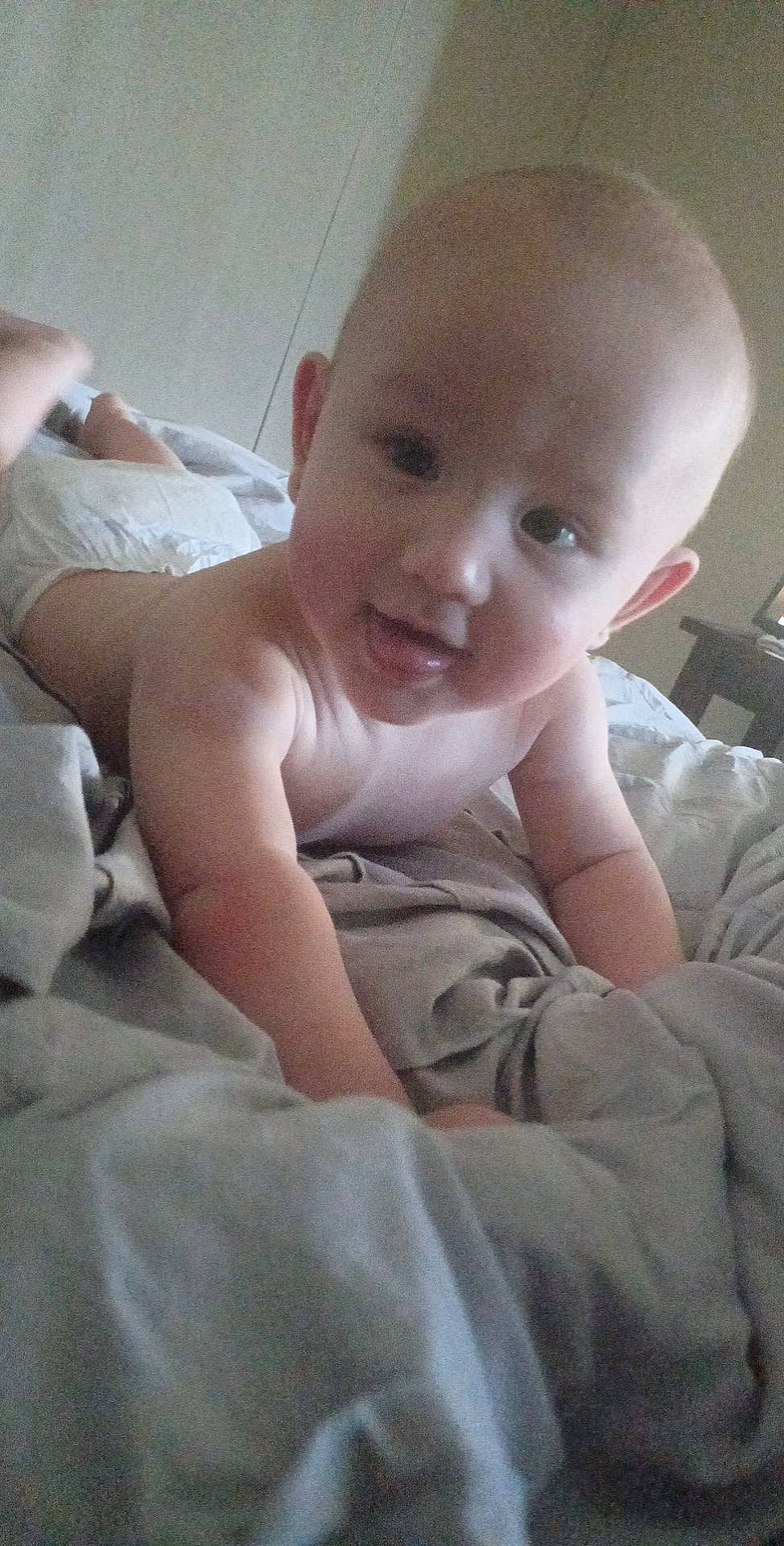 William joined the competition — help win amazing prizes! baby, baby_toddler_clothing, bed, cheek, chest, child, comfort, finger, flooring, happy, iris, linens, nose, person, room, sitting, skin, sleeve, smile, thumb