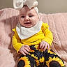 Lakely is registered to the contest to win money with this photo: baby, bib, bow, child, clothing, cute, dimples, happy, headband, indoor, infant, pants, person, pink_blanket, portrait, sitting, smiling, soft_texture, sunflower_pattern, yellow_clothing