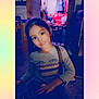 Heavenly Faith is registered to the contest to win money with this photo: child, girl, smile, indoor, clothing, furniture, red_couch, long_sleeve_shirt, handbag, face, earrings, hair, person, portrait, home, room, lighting, casual, young, sitting