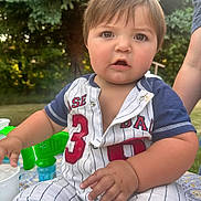 Callum joined the competition — help win amazing prizes! toddler, child, baby, outdoor, greenery, baseball_outfit, striped_clothing, curious_expression, sitting, summer, daylight, portrait, young_child, cute, plump_arms, short_hair, table, hand, person, nature