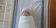 Ariona is registered to the contest to win money with this photo: baby, bed, blanket, cradle, crib, face, furniture, head, infantbed, newborn, person