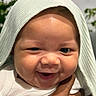 Brayden is registered to the contest to win money with this photo: baby, smiling, face, child, infant, hand, tattoo, cloth, white_clothing, closeup, cute, happy, skin, eyes, cheeks, person, indoors, portrait, headwear, expression