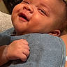 Brayden is registered to the contest to win money with this photo: baby, smile, face, hand, blue_towel, infant, skin, closeup, happy, joy, cute, child, portrait, newborn, expression, soft_texture, warmth, person, head, eyes